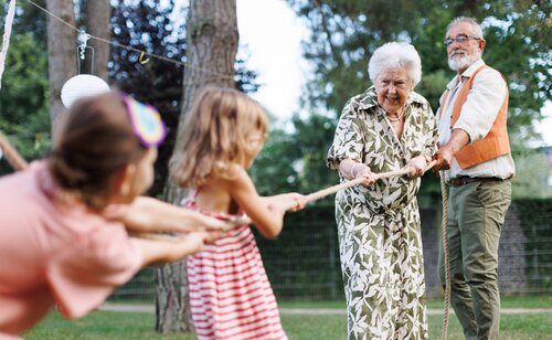 Abuelos jugando con sus nietos al aire libre