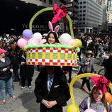 Un padre lleva a hombros a su hija disfrazada de cesta de Pascua