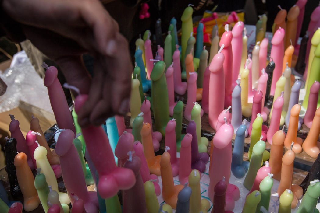 Un hombre compra una vela con forma de pene para el Festival del Falo de Metal