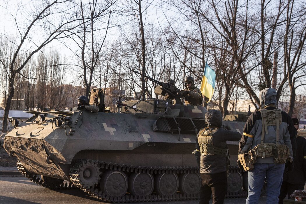 El ejército ucraniano con un vehículo blindado atravesando el puesto de control de Obolon, en Kiev